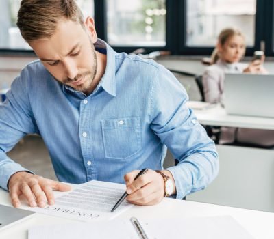young-businessman-working-with-contract-in-office-2023-11-27-05-04-57-utc (1)