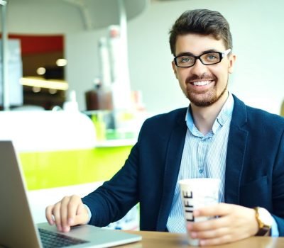young-man-working-at-his-laptop-indoors-2023-11-27-05-07-21-utc (1)